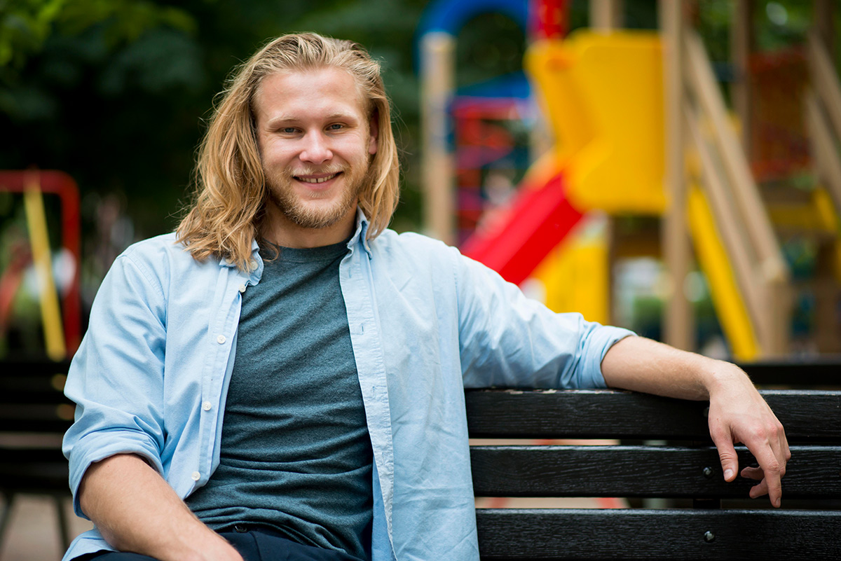 front-view-cheerful-man-posing-outdoors