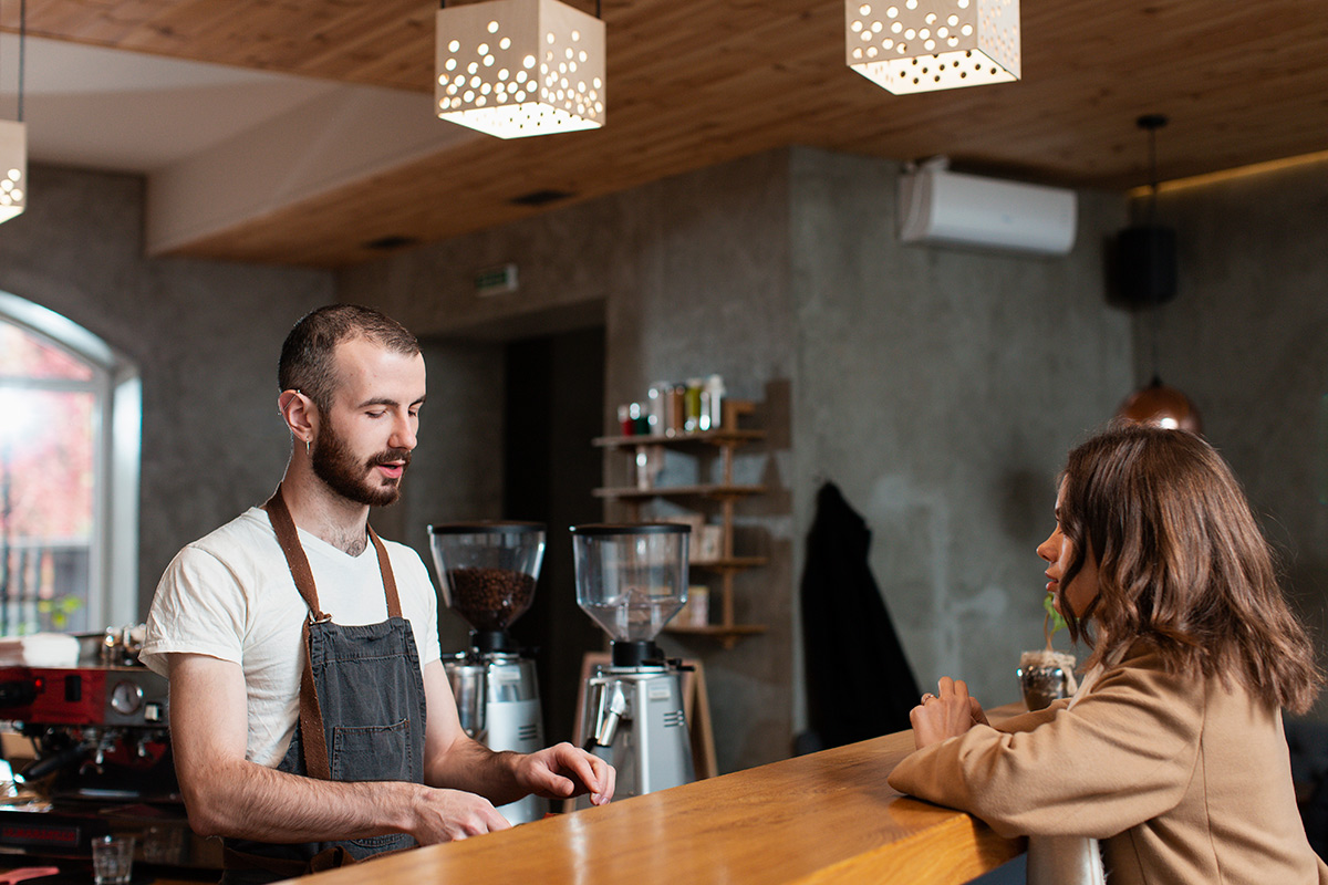 man-apron-preparing-coffee-customer